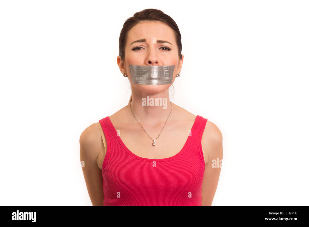 abused woman in red with gaffer tape on her mouth experiencing emotional pain isolated Stock Photo