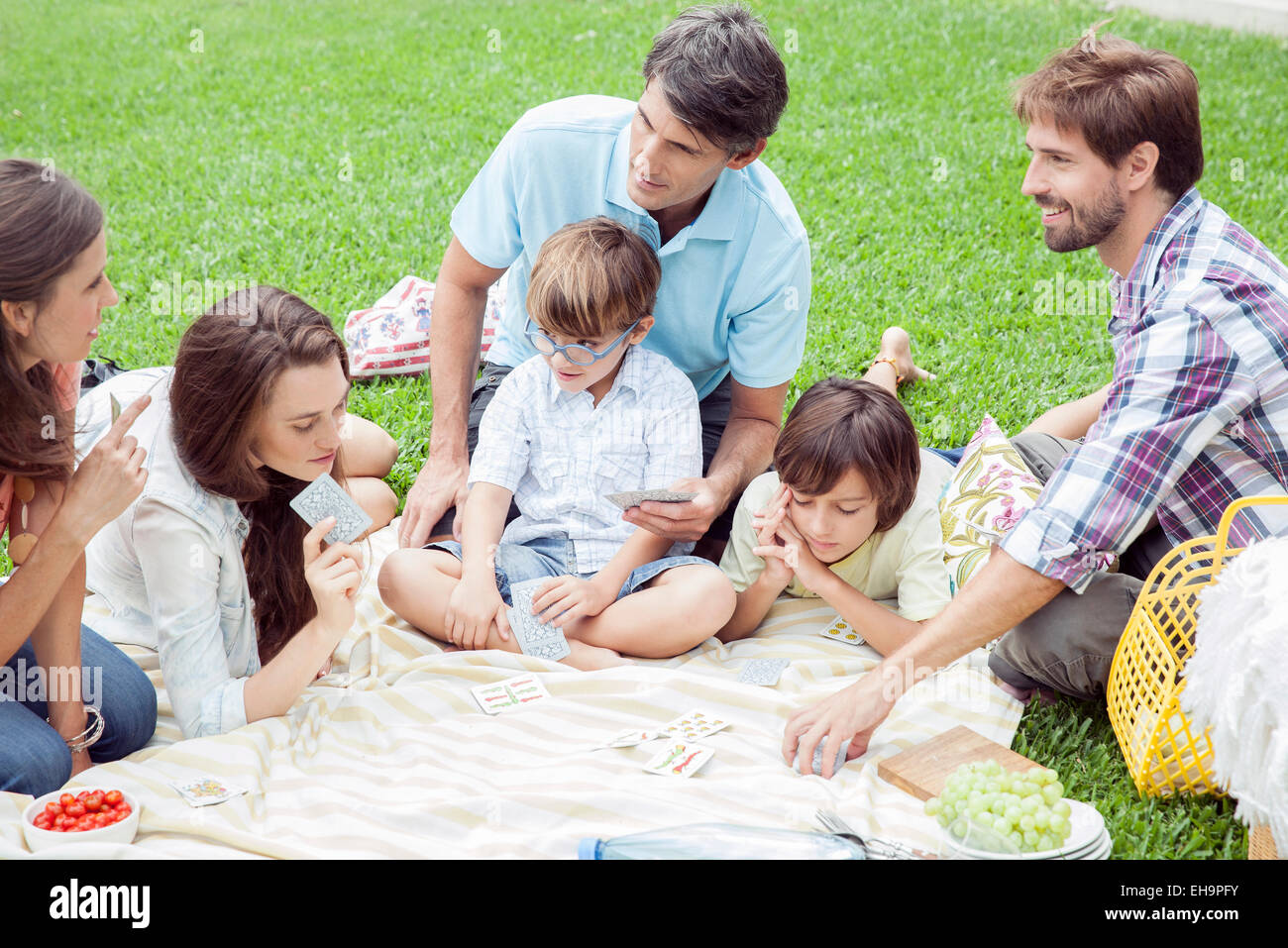 Family playing card game at picnic Stock Photo Alamy