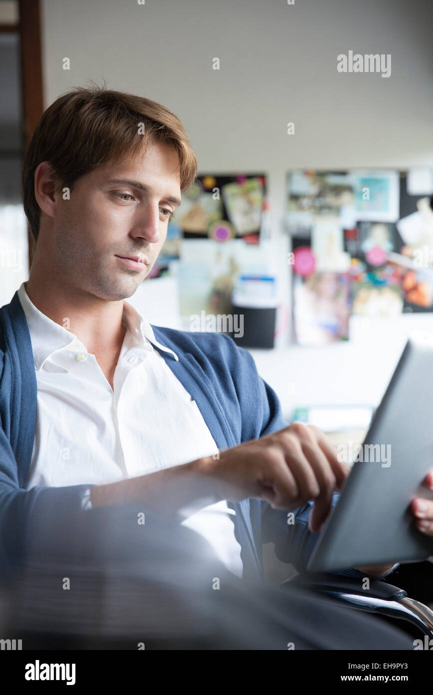 Man using digital tablet in office Stock Photo