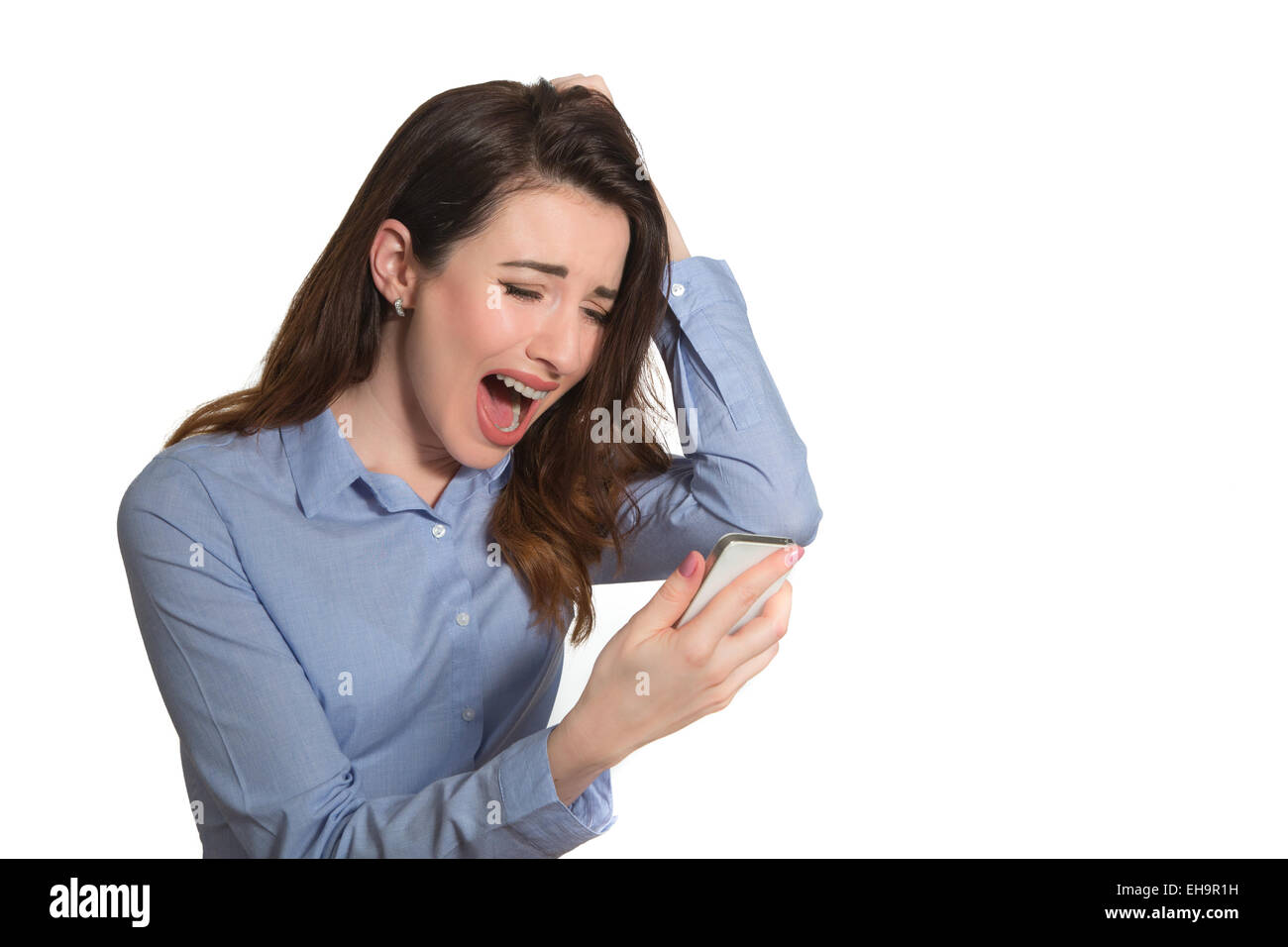 Screaming lady reading text on mobile phone touching her head in despair isolated on white background Stock Photo