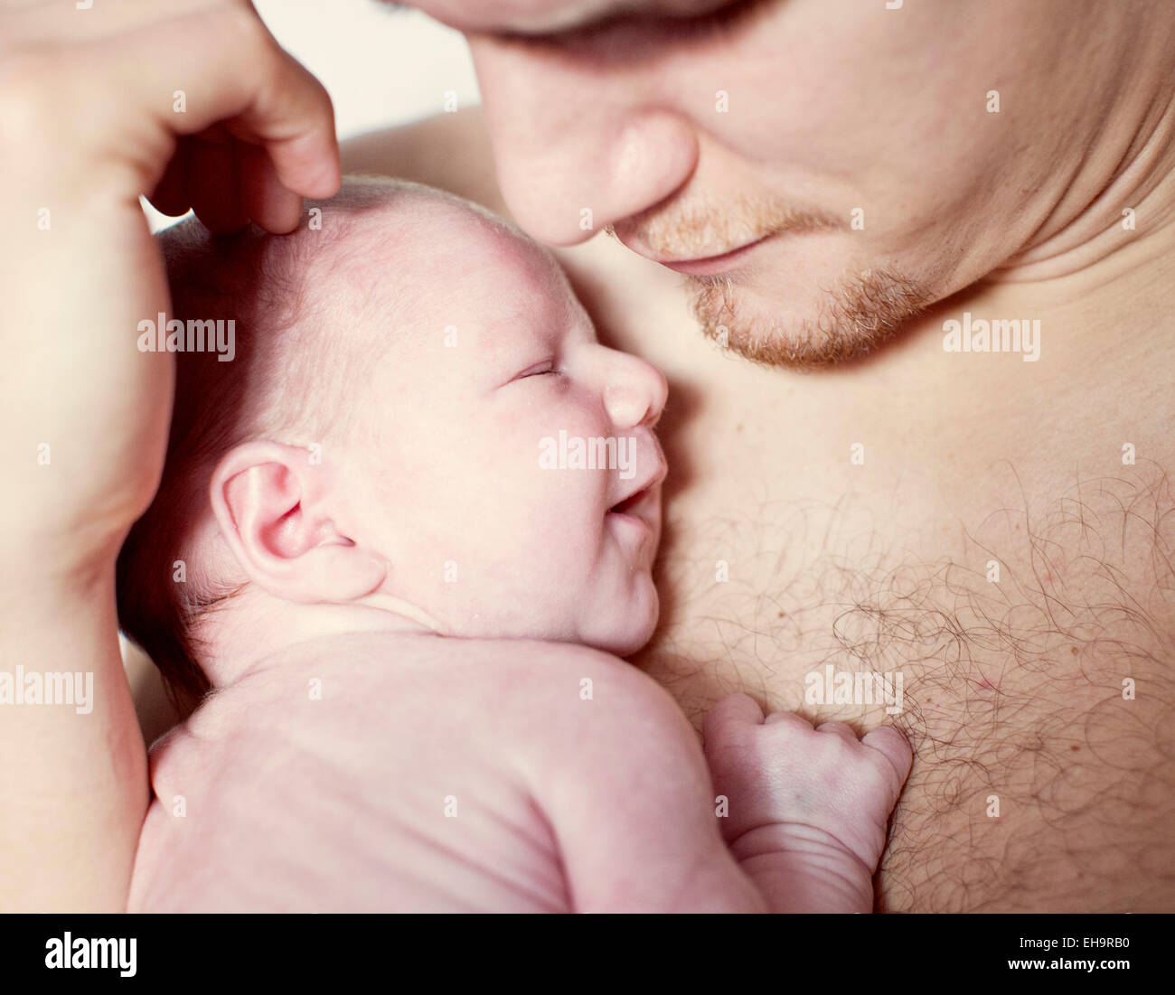 Father comforting newborn baby, close-up Stock Photo