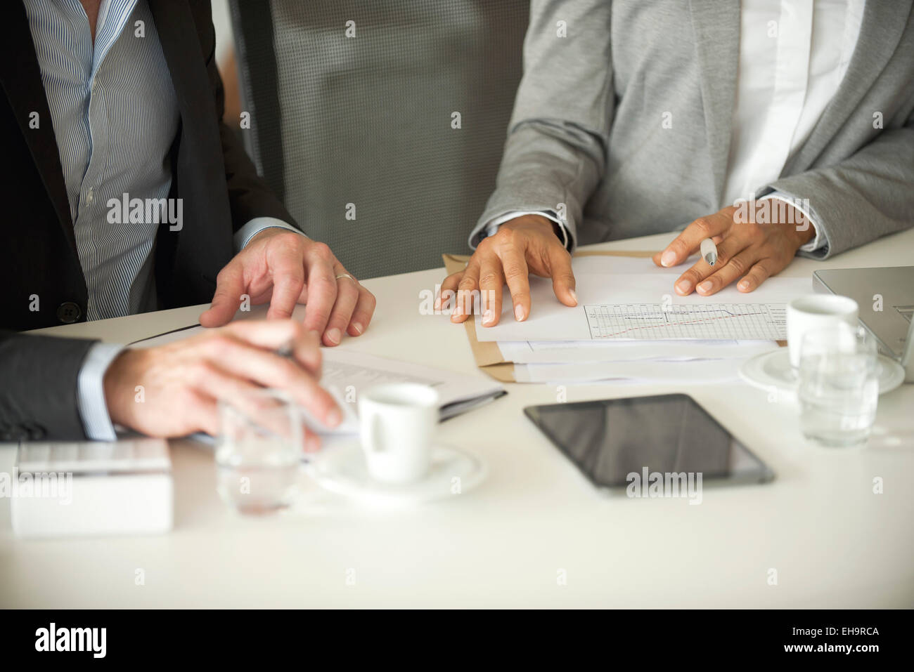 Business associates working together, cropped Stock Photo