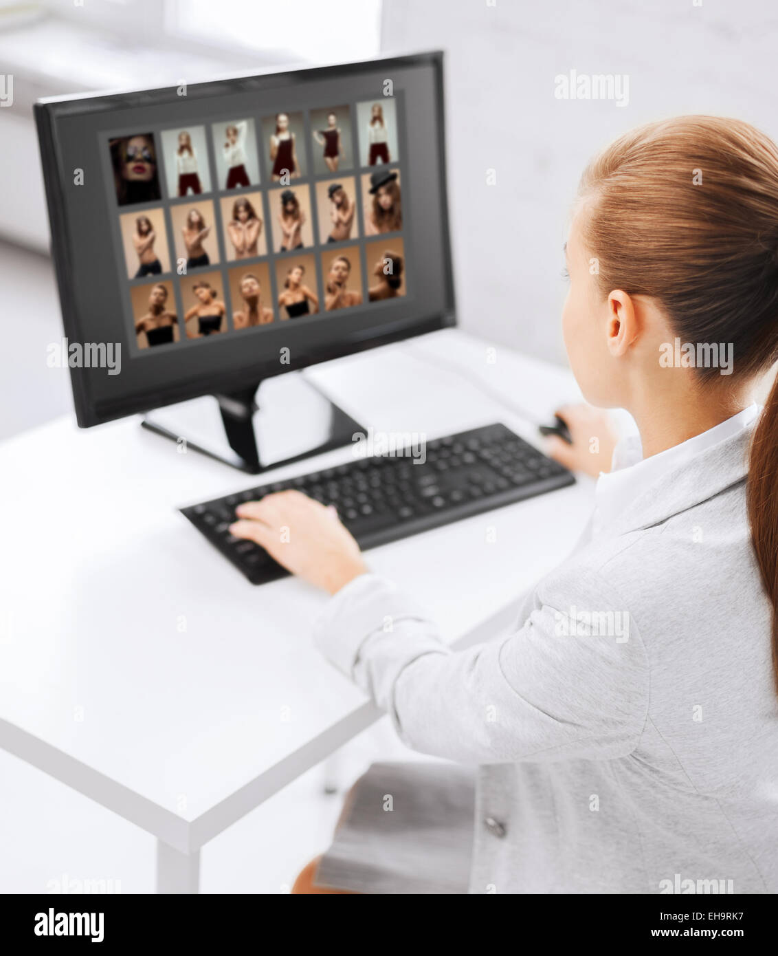 editor choosing pictures from computer monitor Stock Photo