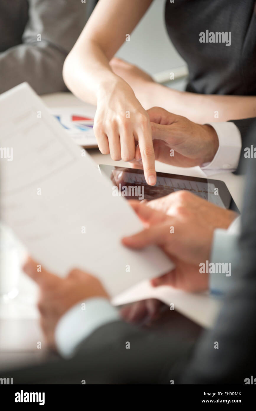 Executives reviewing document in meeting, cropped Stock Photo