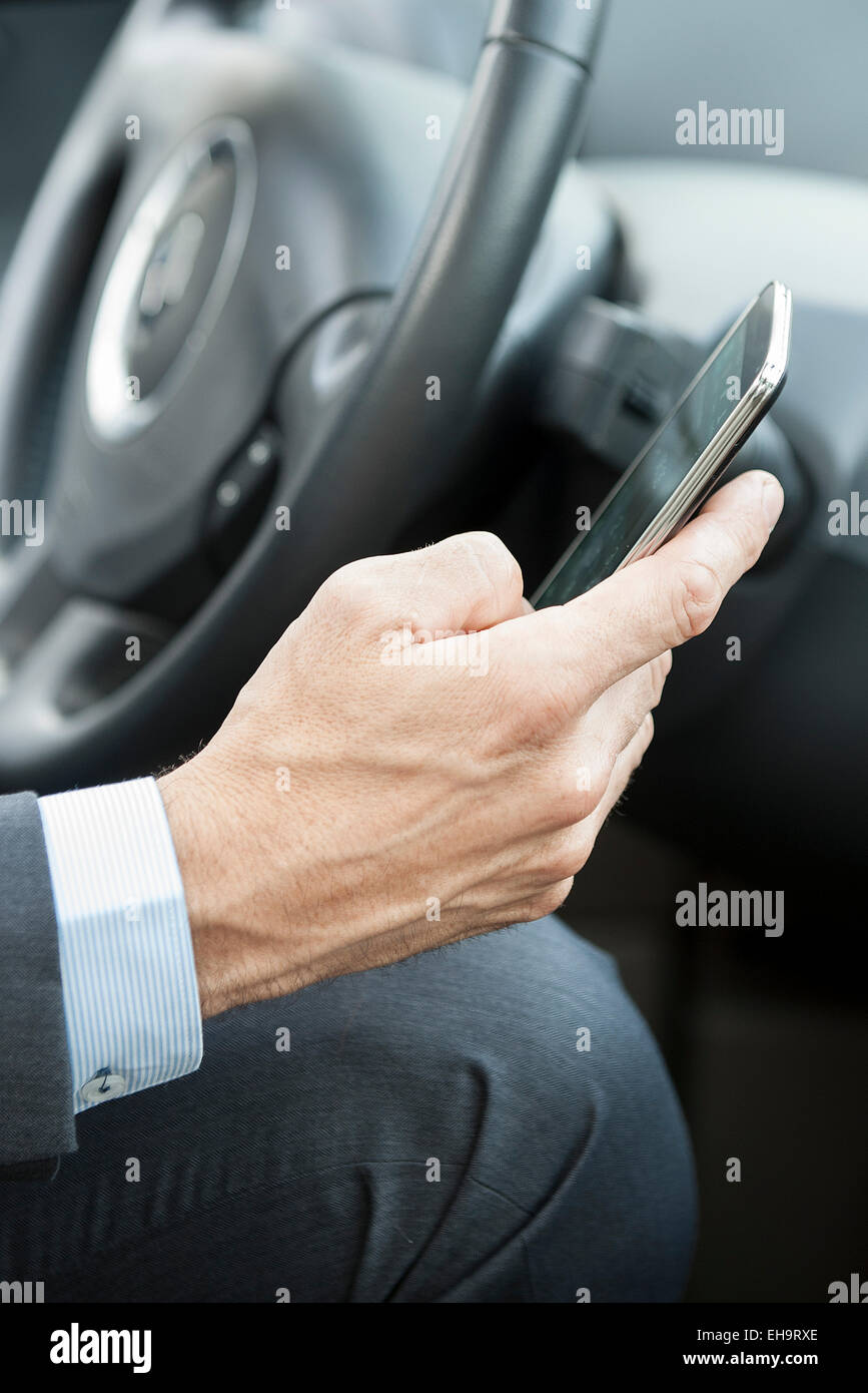 Cell phones can be dangerous distractions while driving Stock Photo