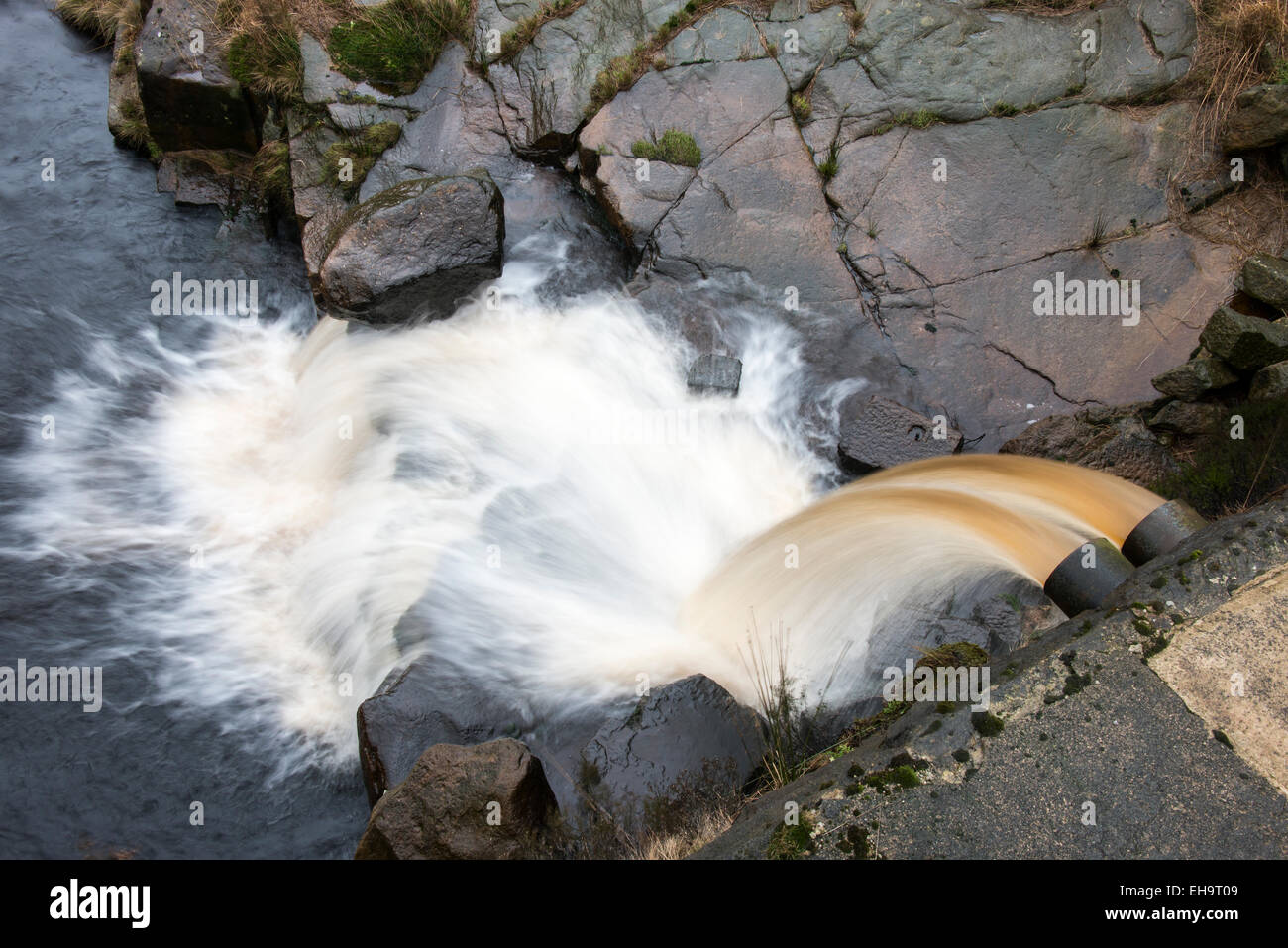 Overflow chute with runningh water from a small dam built to catch the water of a moorland