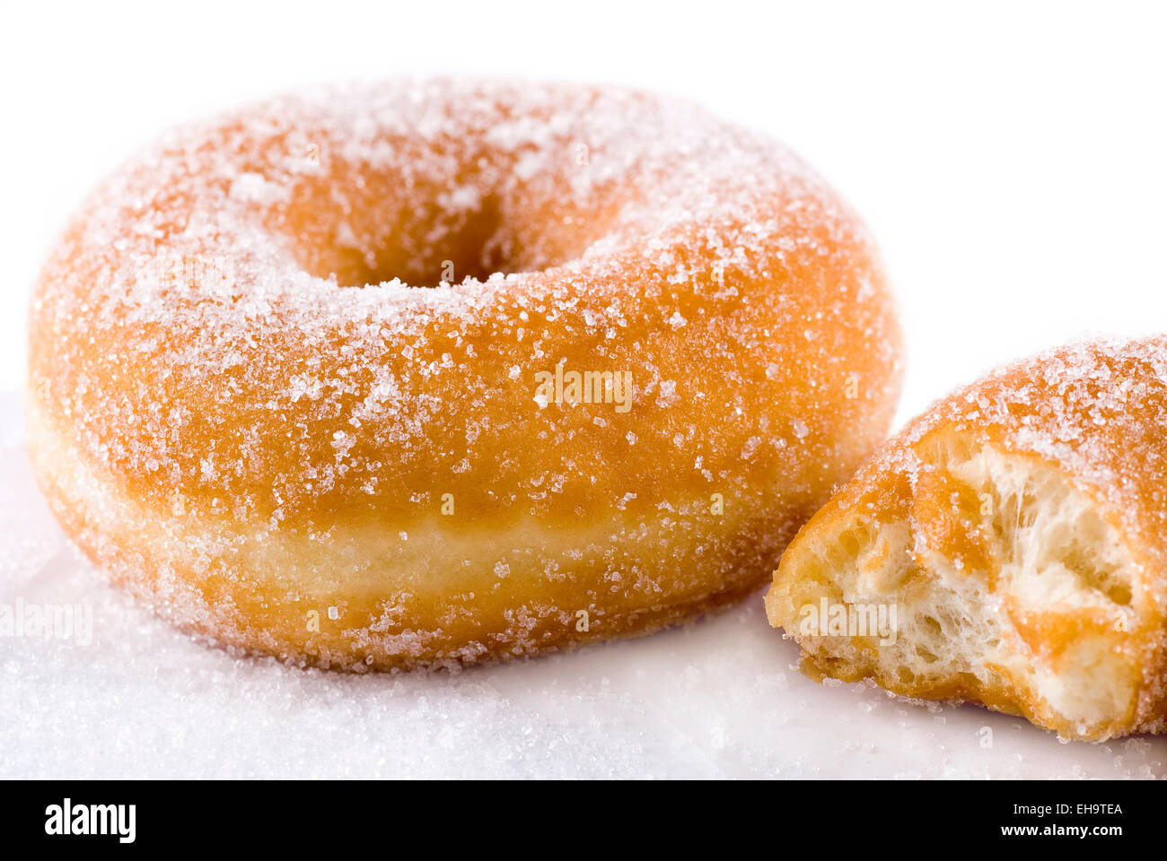 Sugar donut on greaseproof paper. Stock Photo