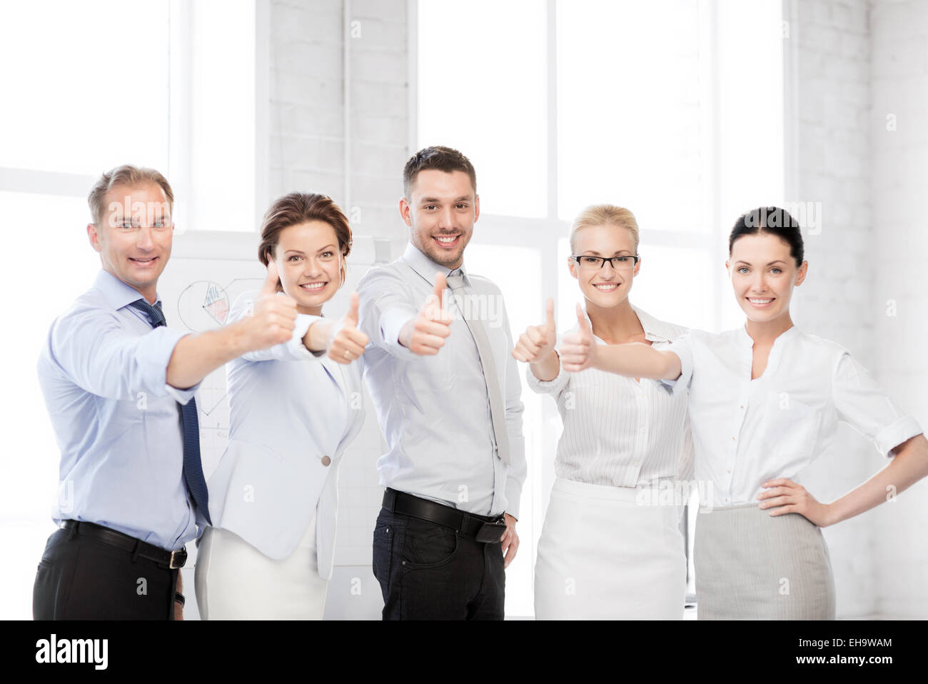 business team showing thumbs up in office Stock Photo - Alamy
