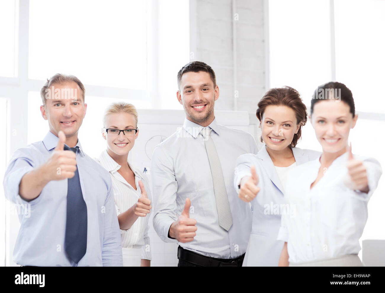business team showing thumbs up in office Stock Photo - Alamy