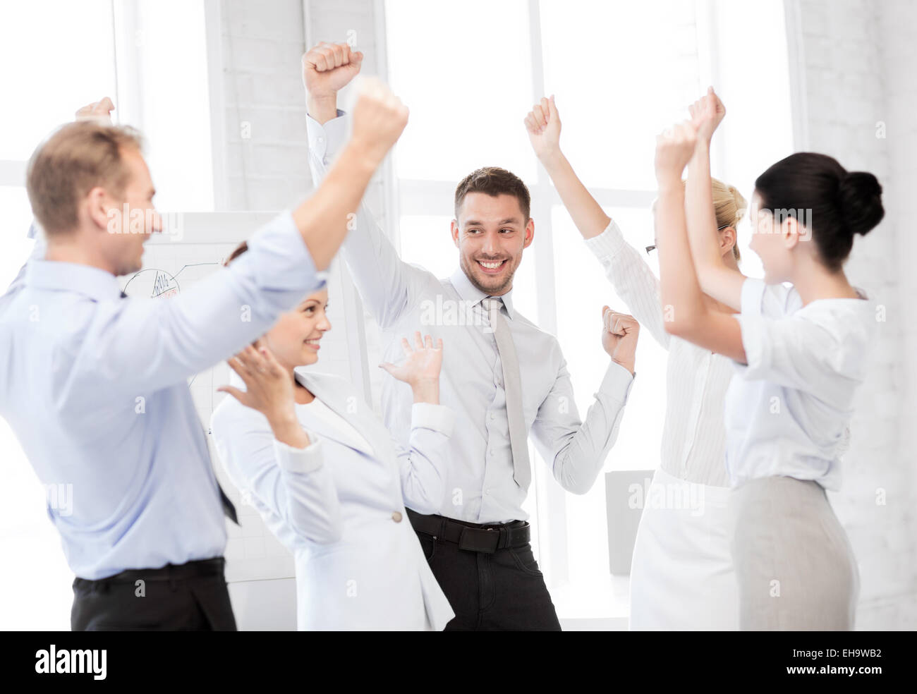 business team celebrating victory in office Stock Photo - Alamy