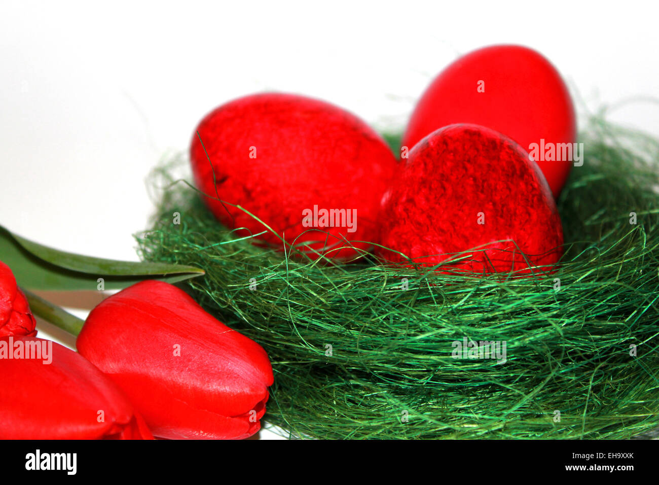 Colored easter eggs and red tulips bouquet Stock Photo - Alamy