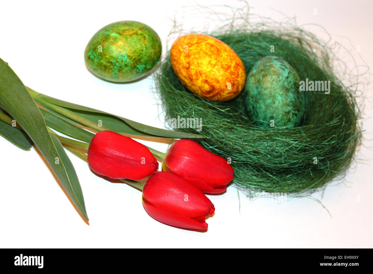 Colored easter eggs and red tulips on white background Stock Photo - Alamy