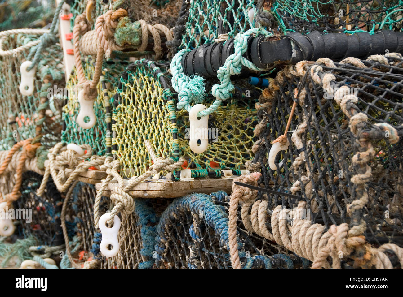 Colourful lobster pots stacked on the Chicken Run, Bridlington Harbour, East Yorkshire, UK Stock Photo