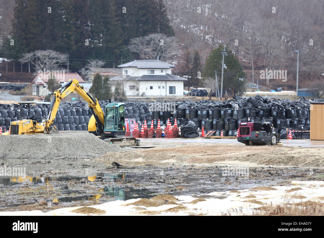 (150310) -- FUKUSHIMA, March 10, 2015 (Xinhua) -- Black bags containing buildup of contaminated wastes are seen in the town of Iitate, Fukushima Prefecture, Japan, March 7, 2015. The scenes from the towns and villages still abandoned four years after an earthquake triggered tsunami breached the defenses of the Fukushima Daiichi nuclear power plant, would make for the perfect backdrop for a post- apocalyptic Hollywood zombie movie, but the trouble would be that the levels of radiation in the area would be too dangerous for the cast and crew. The central government's maxim of 'Everything is unde Stock Photo