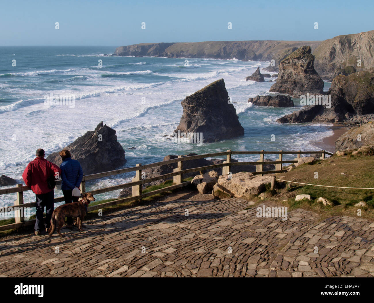 Couple at viewing area looking at Sea stacks at Carnewas known as the  Bedruthan Steps, Cornwall, UK Stock Photo