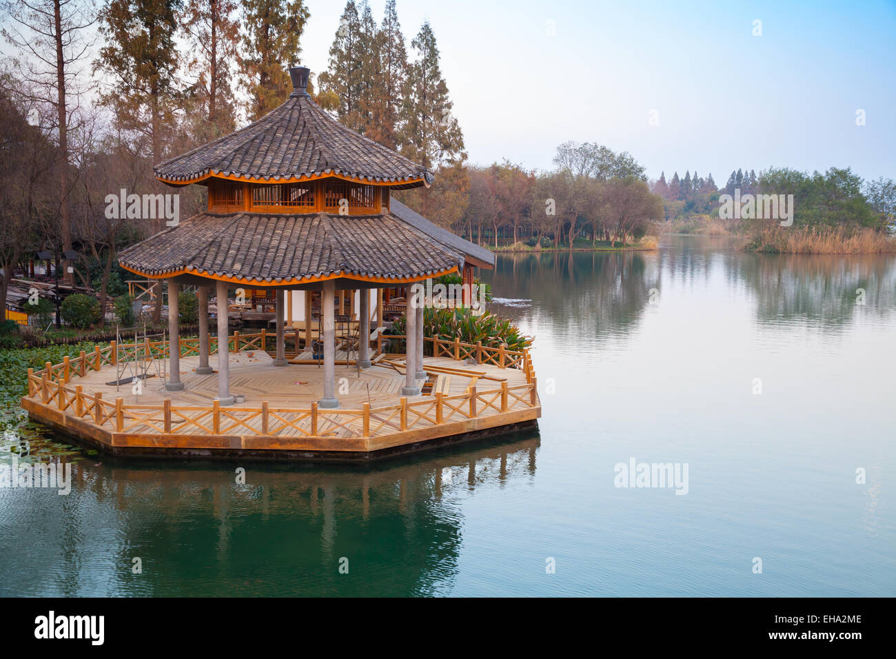 Round traditional Chinese wooden gazebo on the coast of West Lake park in Hangzhou city, China Stock Photo