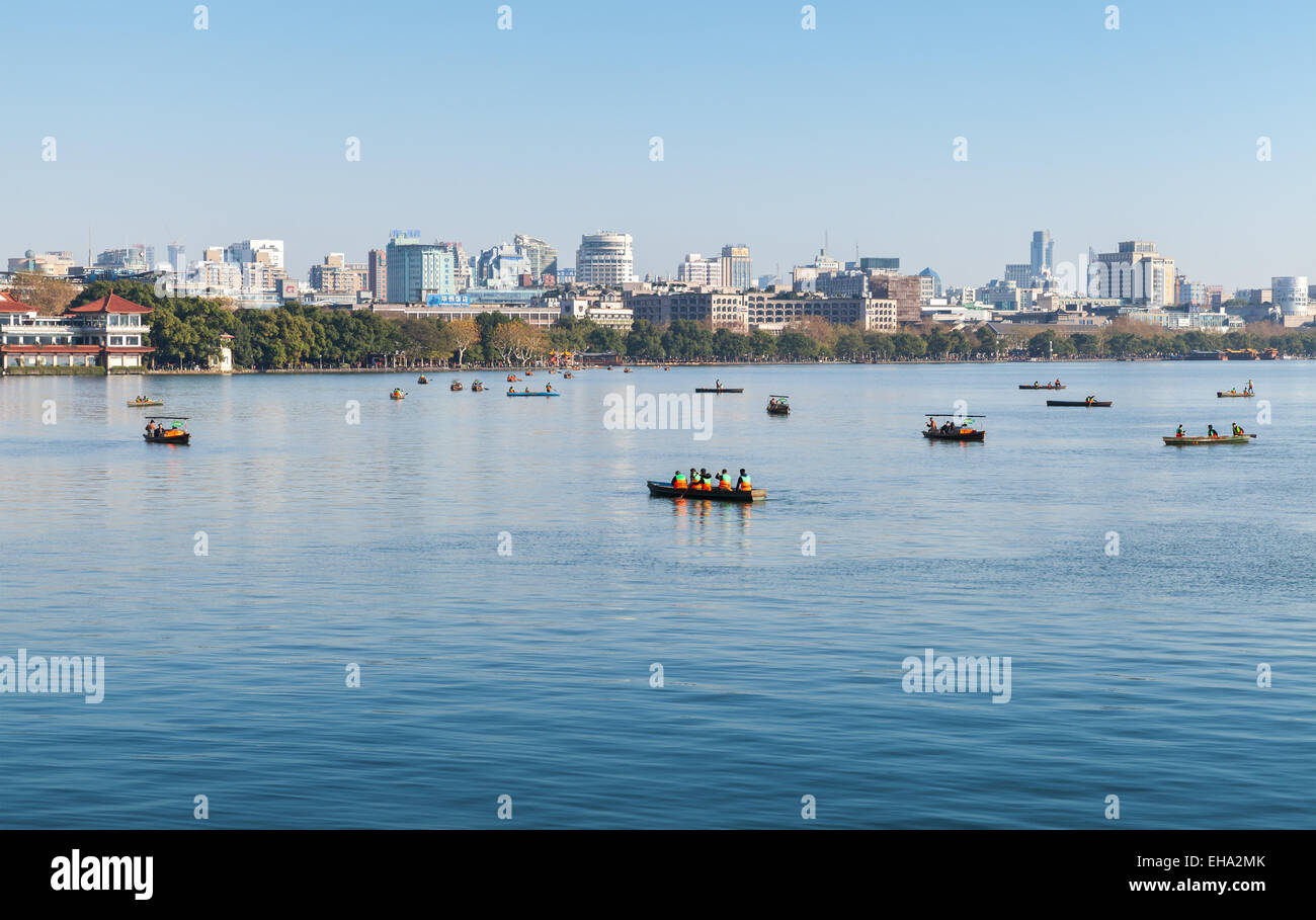 Hangzhou, China - December 5, 2014: Coast of West Lake, panorama with ordinary people in floating boats, Hangzhou city, China Stock Photo
