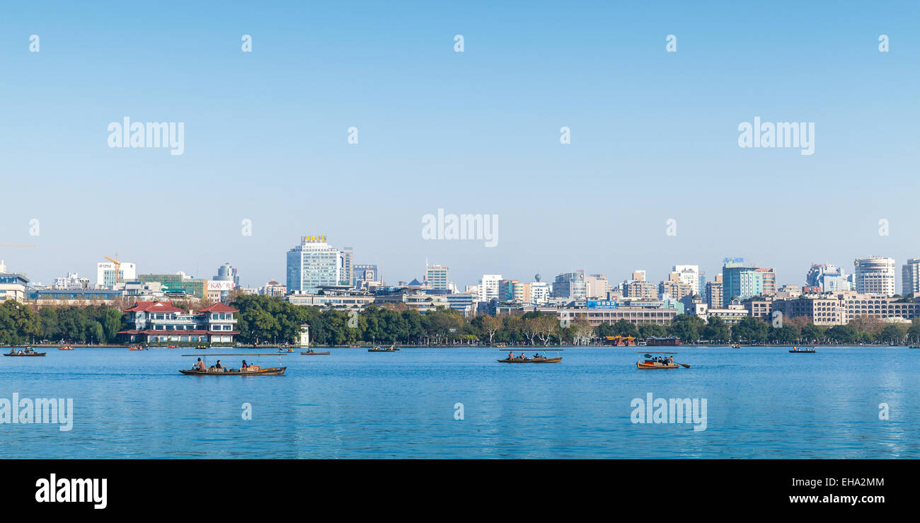 Hangzhou, China - December 5, 2014: The coast of West Lake, panorama with ordinary people in floating boats, Hangzhou city, Chin Stock Photo