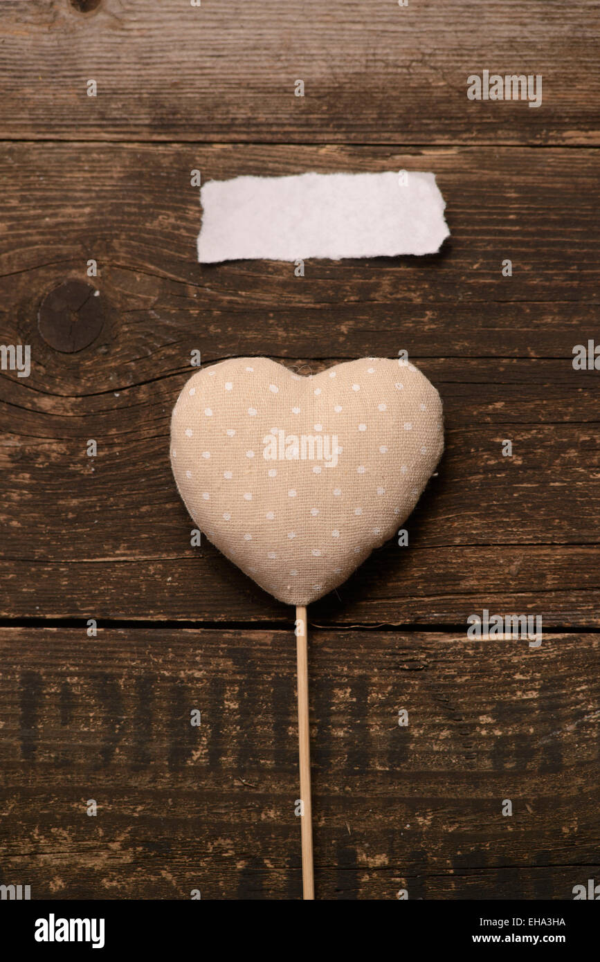 grey heart tissue on a dark wooden background. Valentine's day. Stock Photo