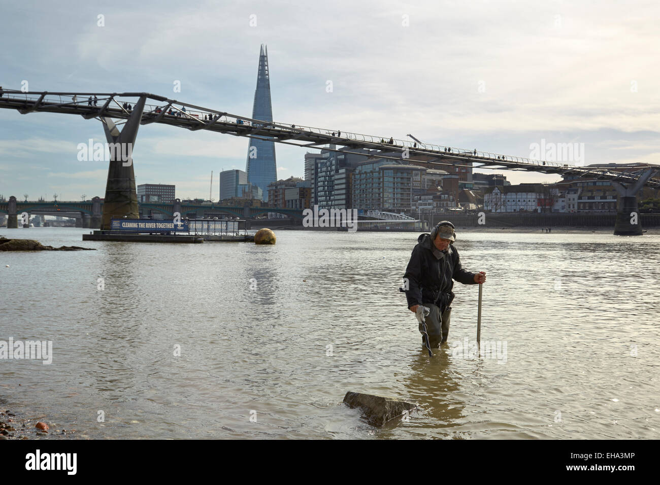 London, UK. 10th March, 2015. A spring low tide on the River Thames and a 'Mudlark' searches for historic lost coins and artefacts Credit:  Steve Hickey/Alamy Live News Stock Photo