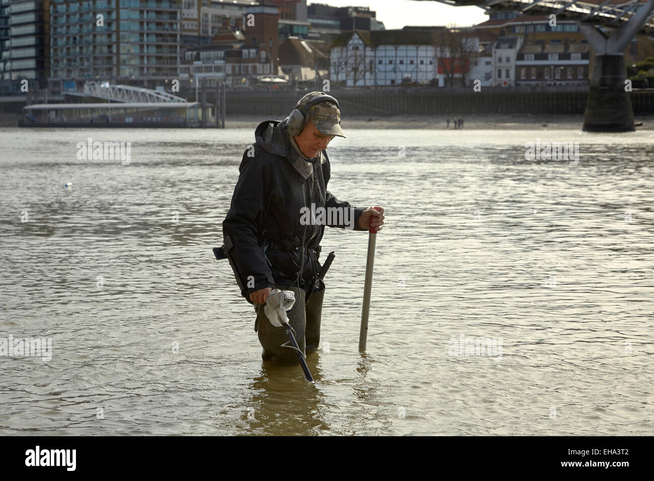 London, UK. 10th March, 2015. A spring low tide on the River Thames and a 'Mudlark' searches for historic lost coins and artefacts Credit:  Steve Hickey/Alamy Live News Stock Photo