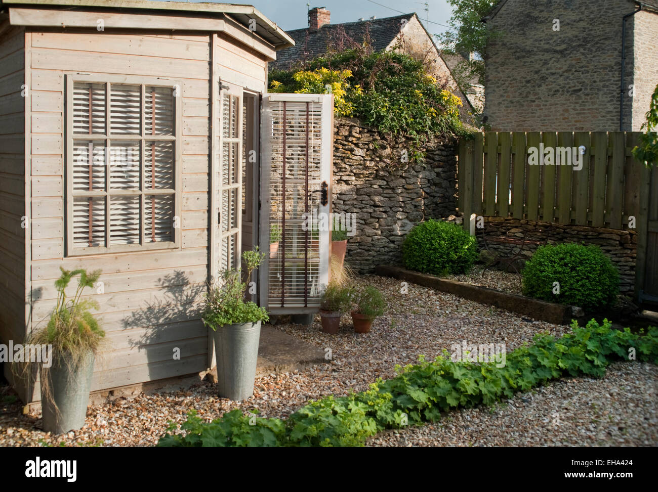 A summerhouse in the garden of a Cotswold cottage, Gloucestershire, England, UK. Stock Photo