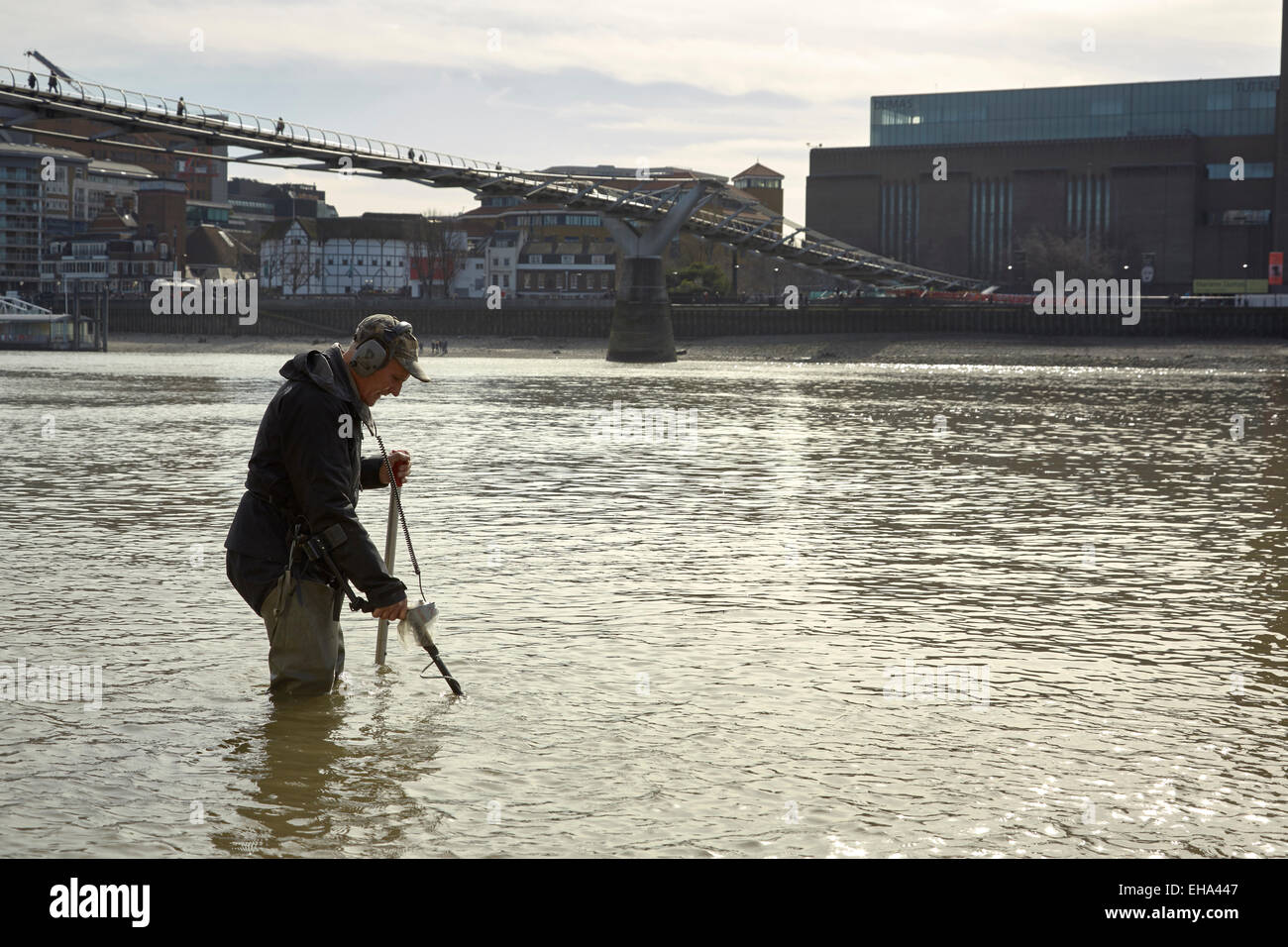 London, UK. 10th March, 2015. A spring low tide on the River Thames and a 'Mudlark' searches for historic lost coins and artefacts Credit:  Steve Hickey/Alamy Live News Stock Photo