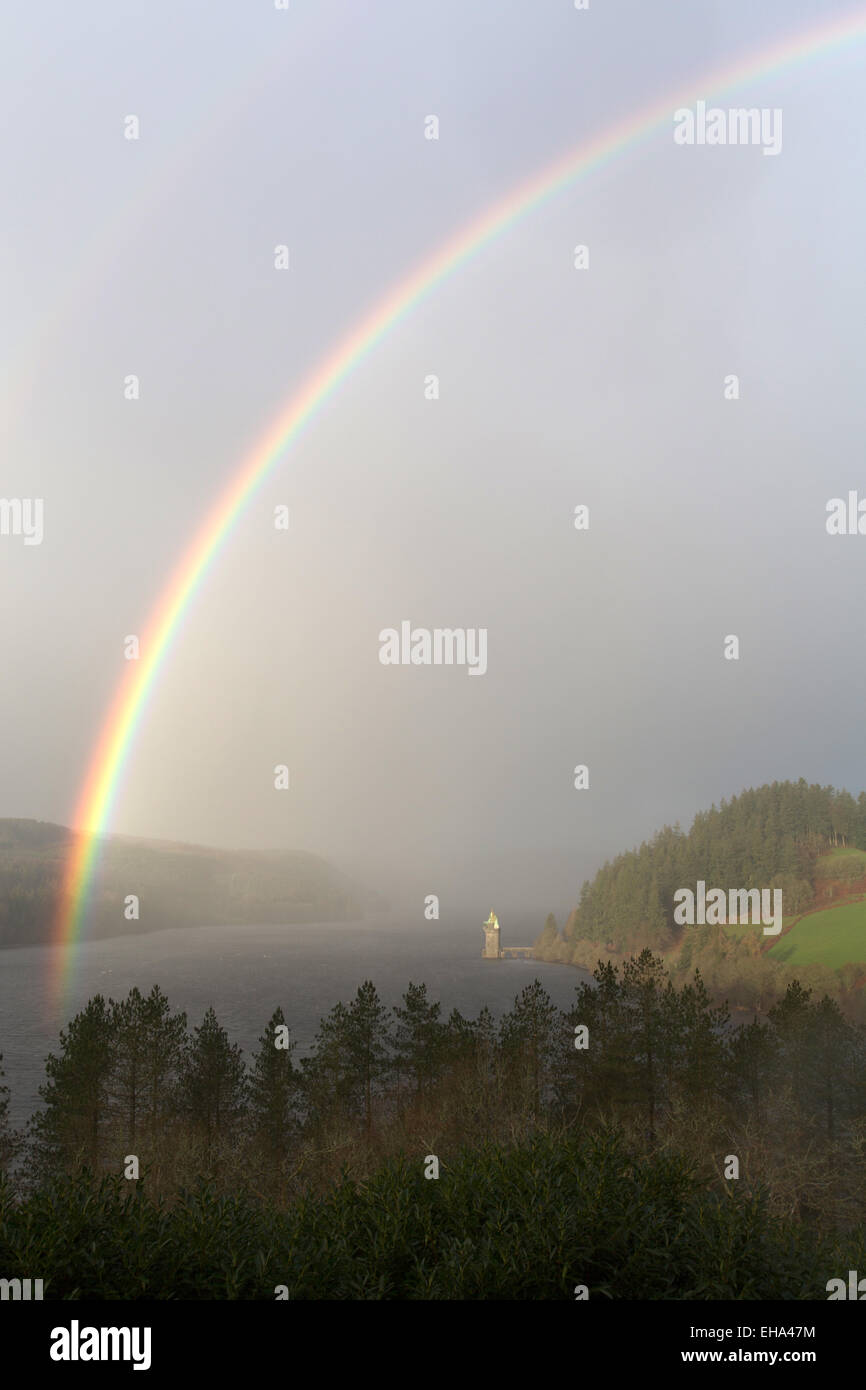 Stunning elevated view of a rainbow forming over Lake Vyrnwy, with the ...