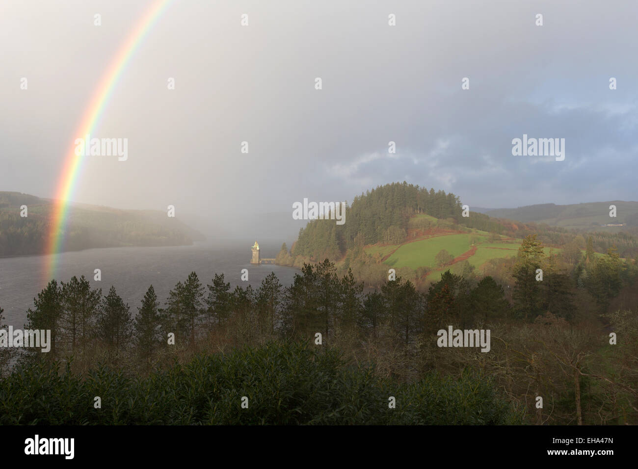 Stunning elevated view of a rainbow forming over Lake Vyrnwy, with the ...