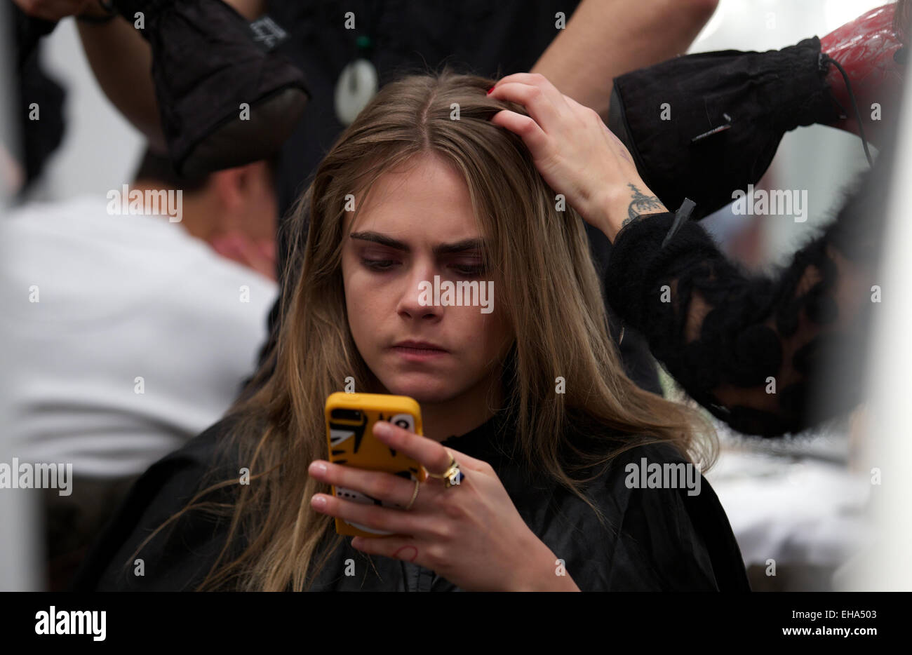 UNITED KINGDOM, London : British model Cara Delevingne gets ready back stage for the Burberry collection during the 2014 Autumn / Winter London Fashion Week in London on February 17, 2014. Stock Photo