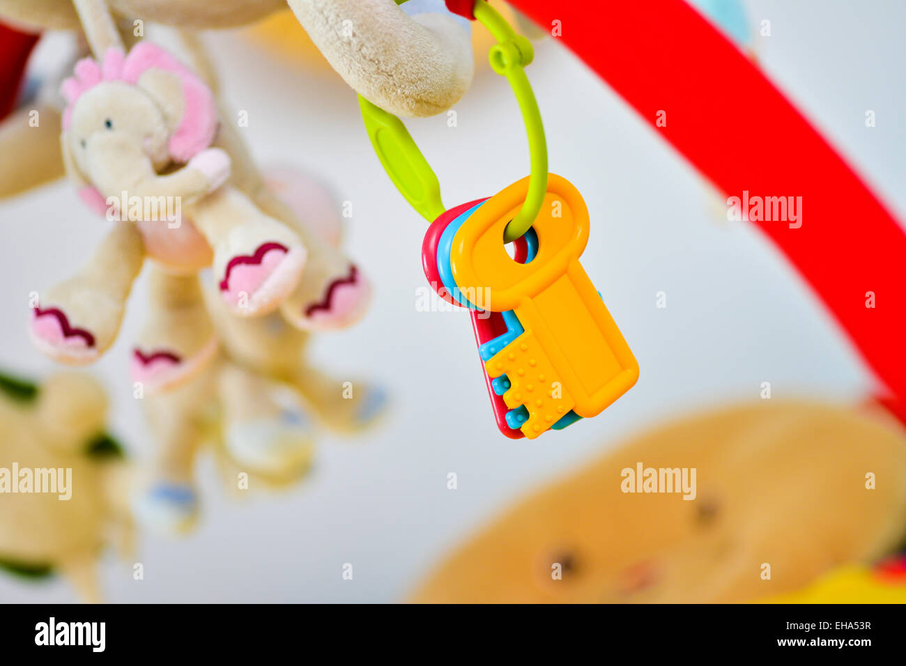 Plastic key for a newborn in a colorful background Stock Photo