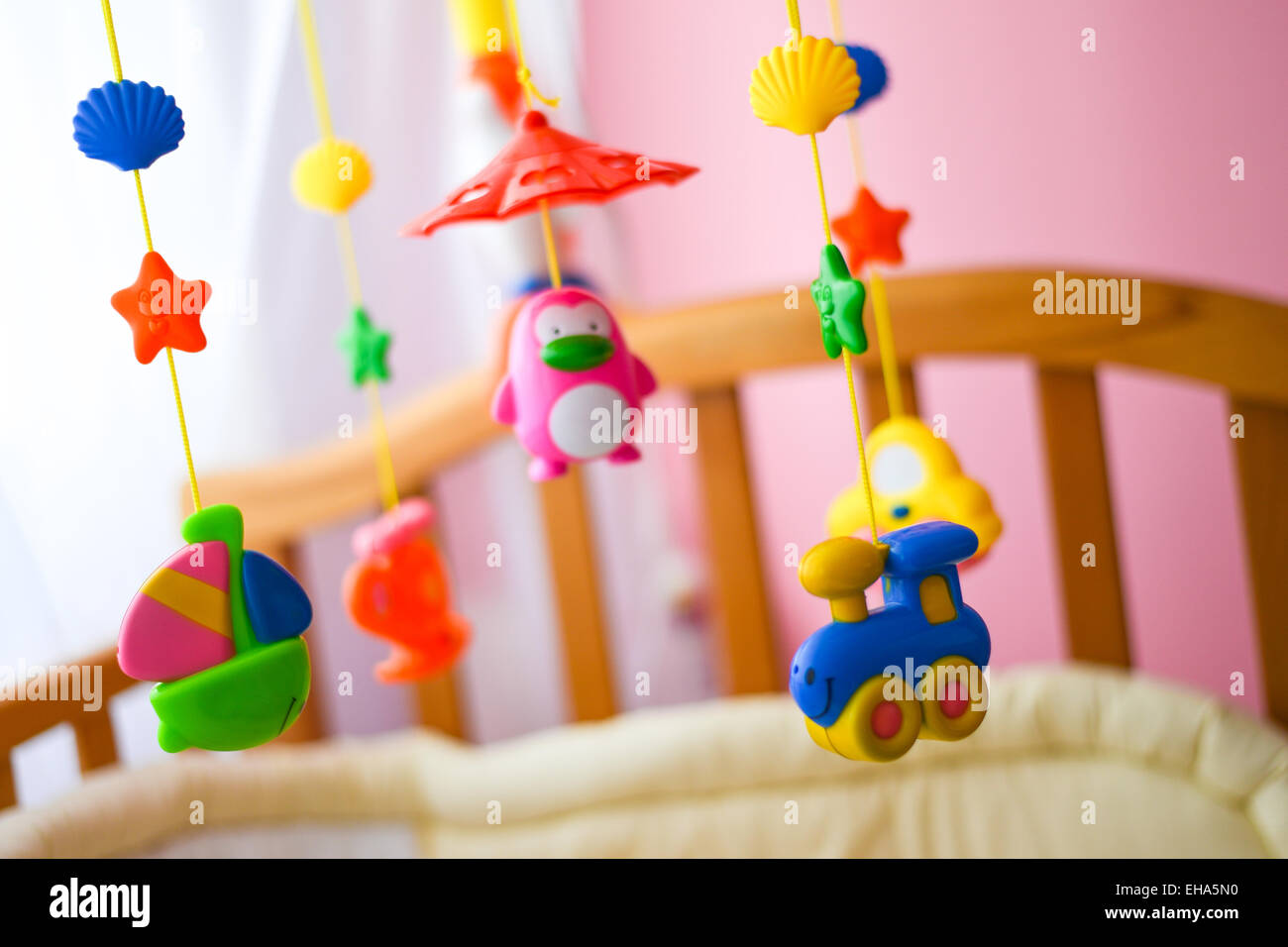 Children toys hanging from the crib Stock Photo Alamy