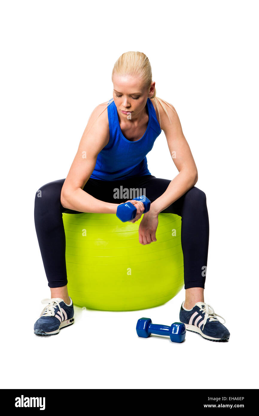 woman wearing fitness clothing exercising with weights Stock Photo