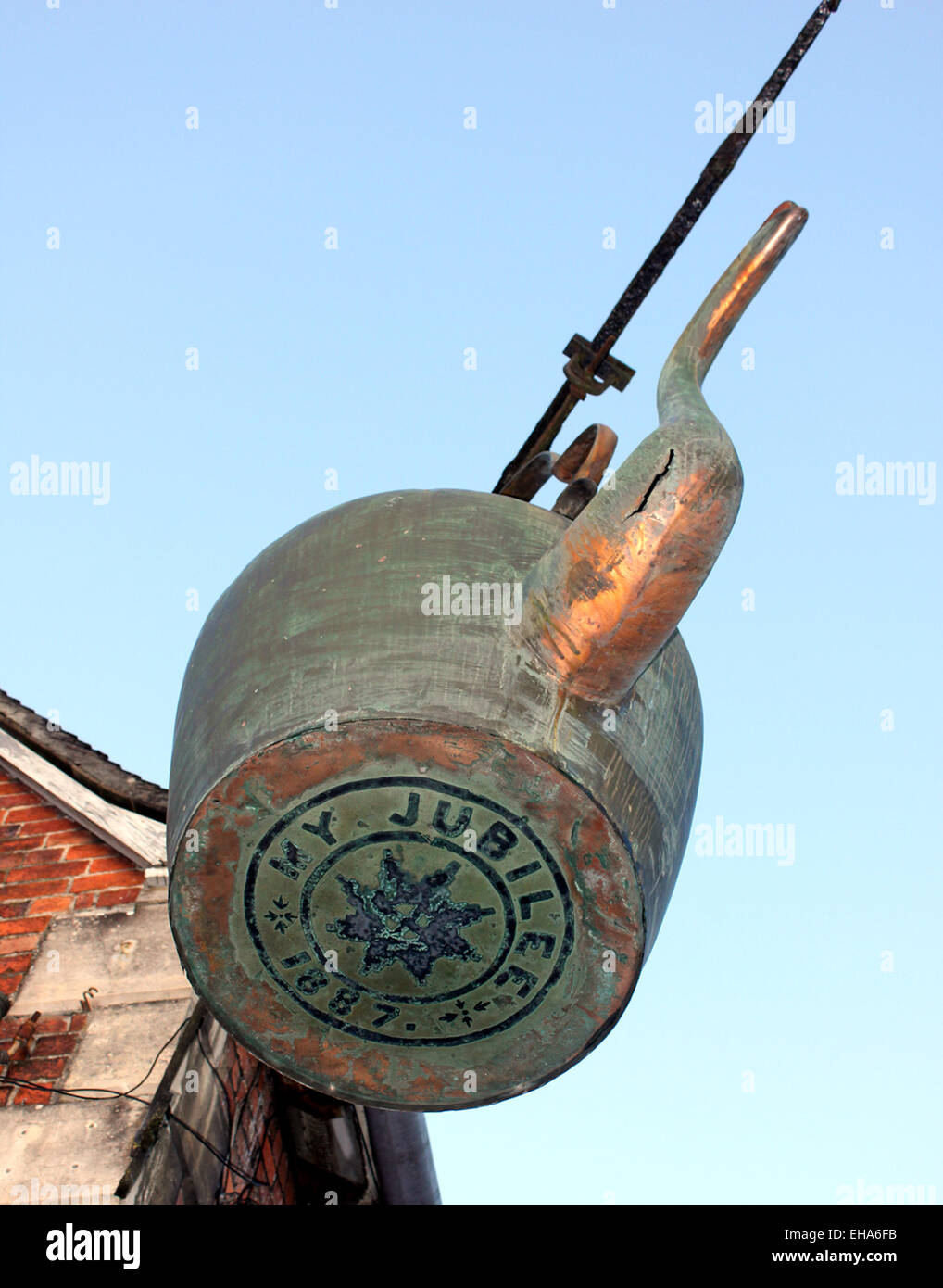 This giant copper kettle hangs from a corner of a building in