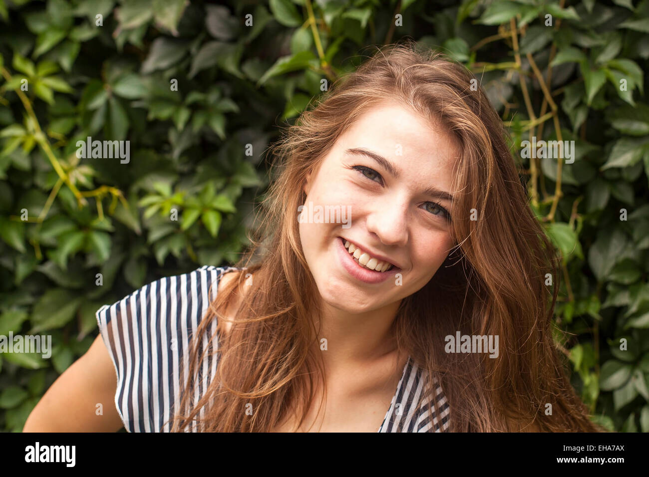 Portrait of a young pretty girl in the park. Stock Photo