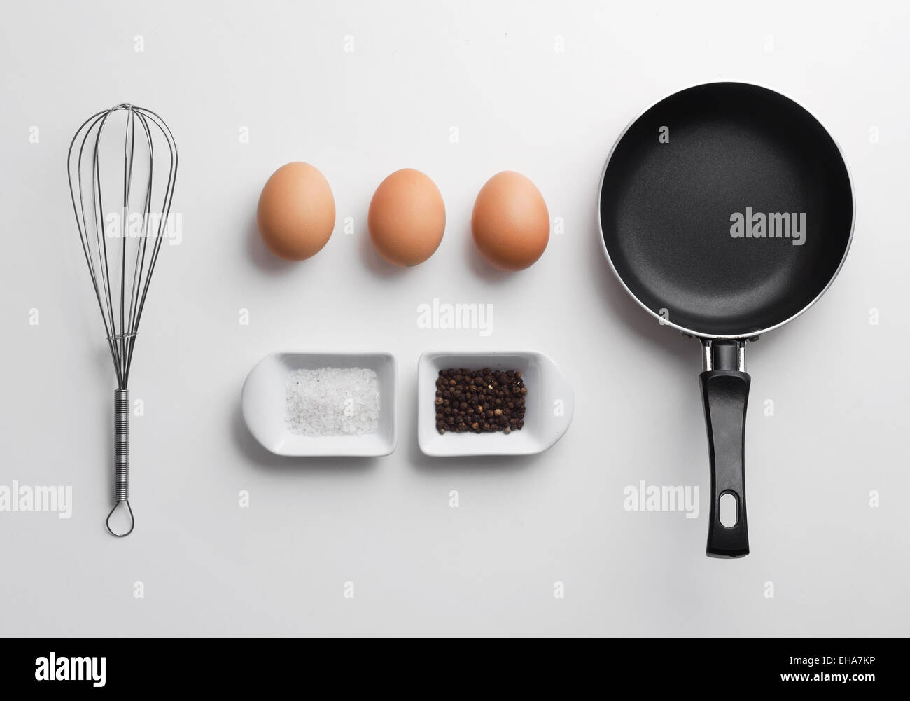 Scrambled eggs ingredients over white table, above view Stock Photo - Alamy
