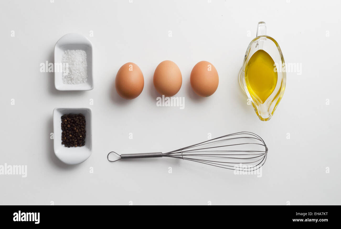 Scrambled eggs ingredients over white table, above view Stock Photo - Alamy