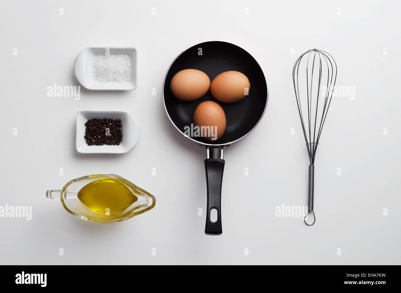 Scrambled eggs ingredients over white table, above view Stock Photo - Alamy