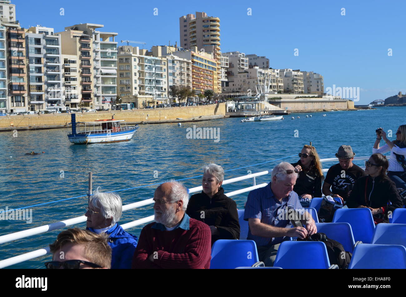 Having enjoyed the tour of theGrand Harbour ofMalta our boat returns to the waters of Sliema and its waterfront hotels once more Stock Photo