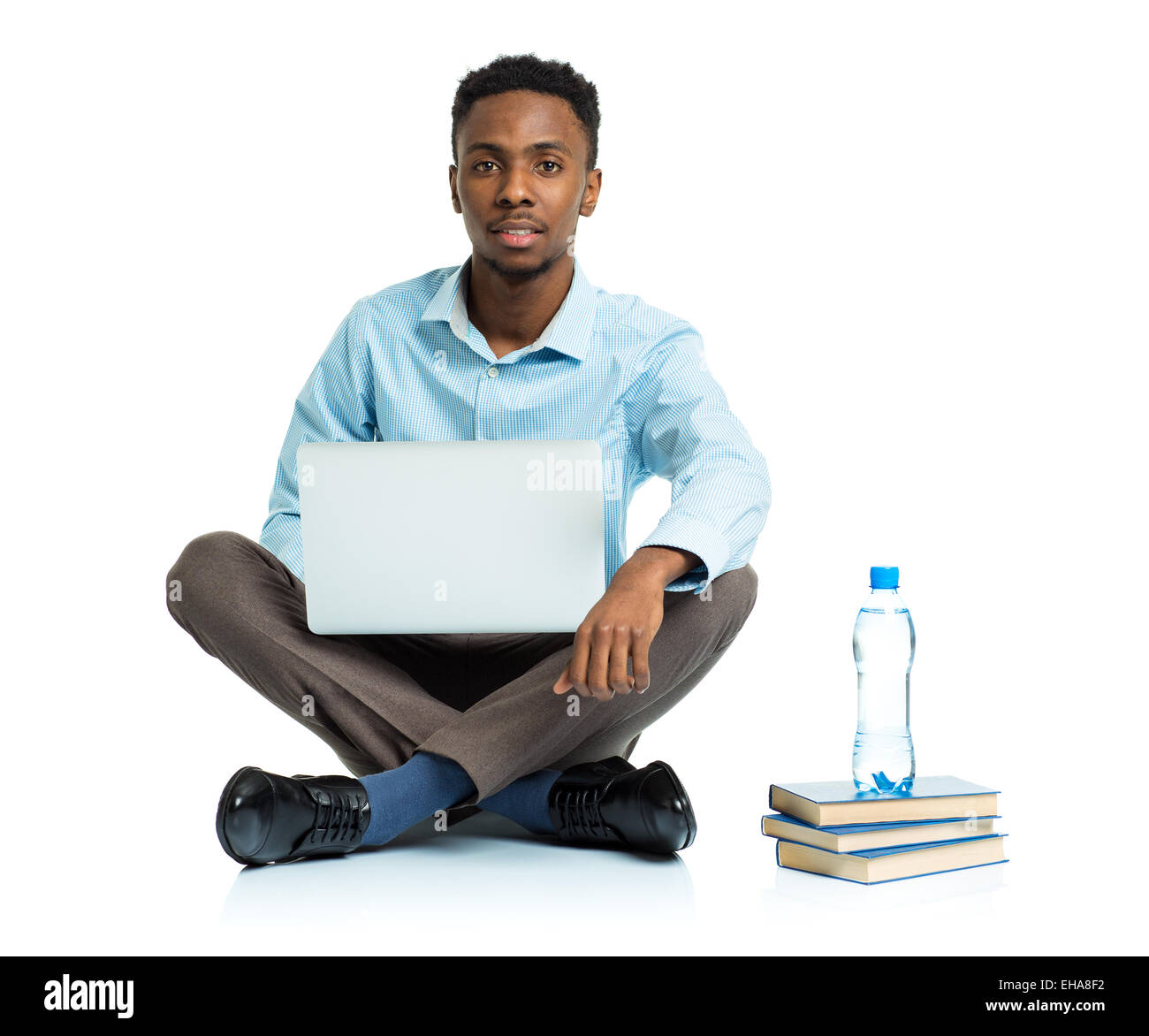 Happy african american college student sitting with laptop on white background Stock Photo