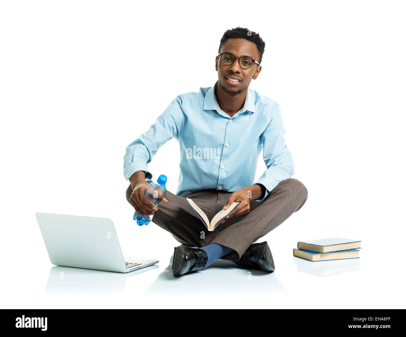 Happy african american college student sitting with laptop on white background Stock Photo