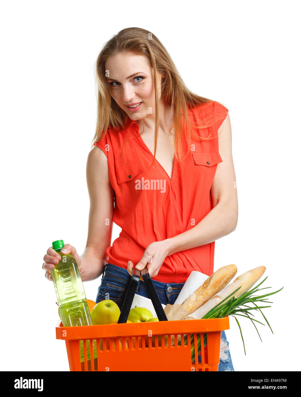 Young caucasian woman with assorted grocery products in shopping basket isolated on white background Stock Photo