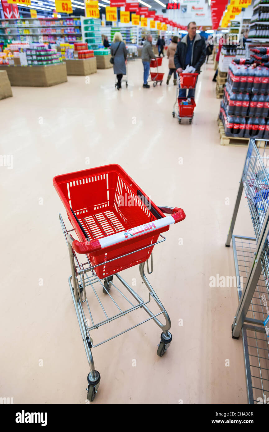 Empty red shopping cart in the interior of Auchan store Stock Photo - Alamy