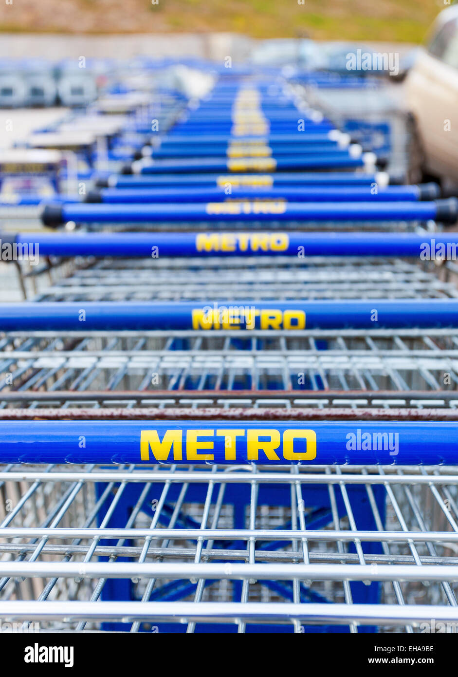 Large empty blue shopping cart Metro store. Metro Group is a German