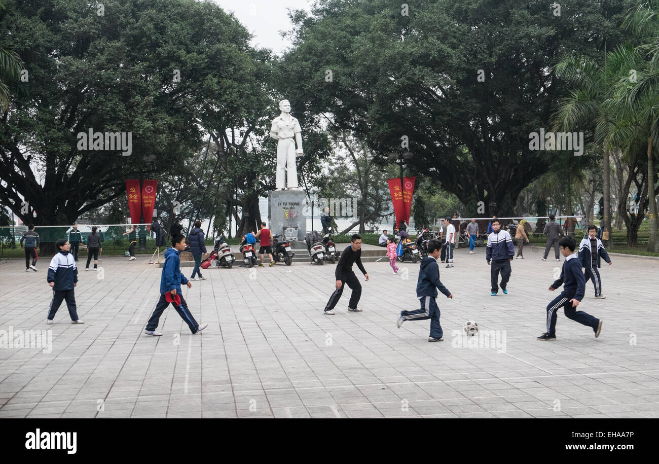 Boys playing football on concrete hard surface near West Lake, Ha Noi,Hanoi, Vietnam, Stock Photo