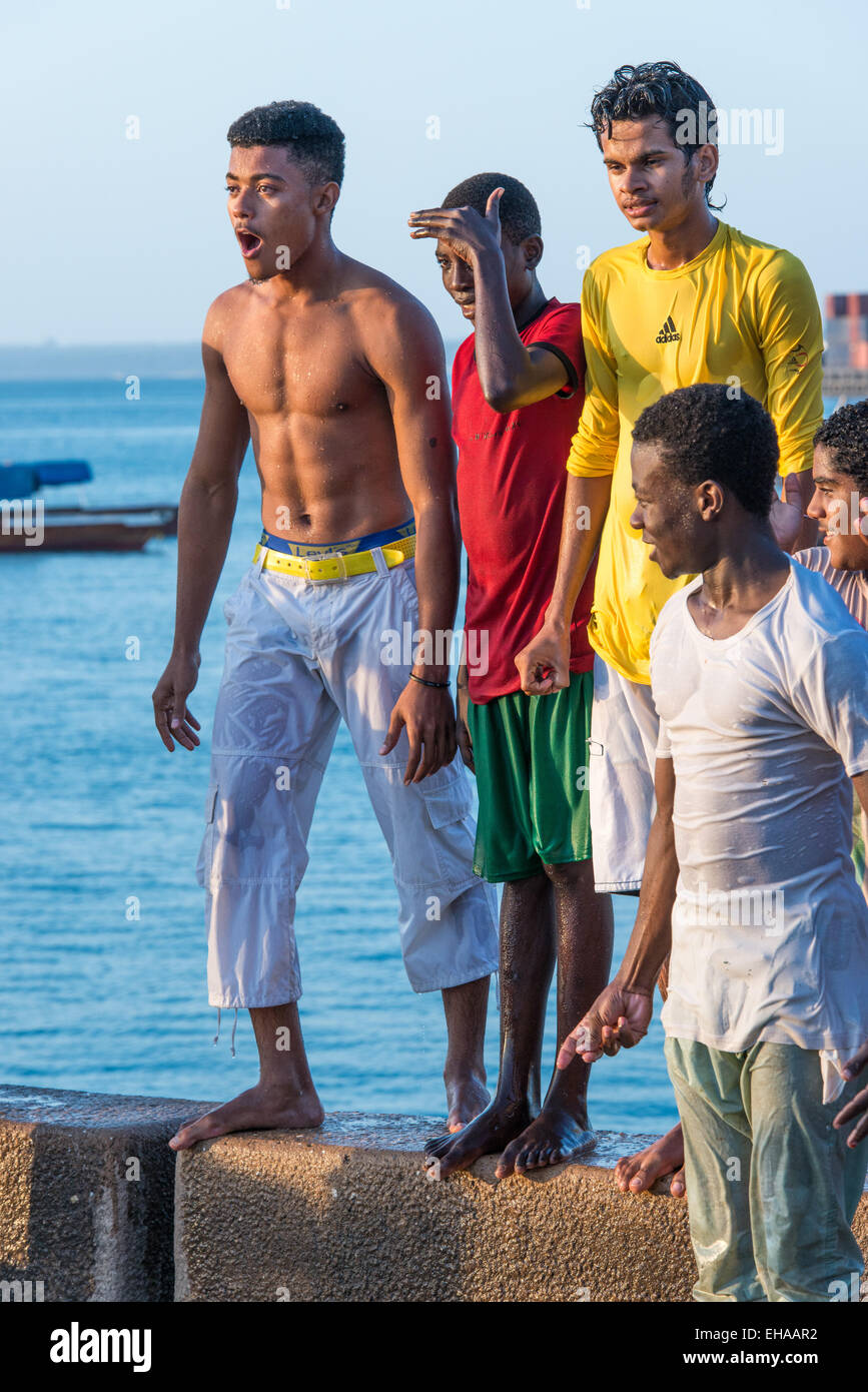 Zanzibar, Stone Town, Young Men Diving Off The Port Stock Photo - Alamy