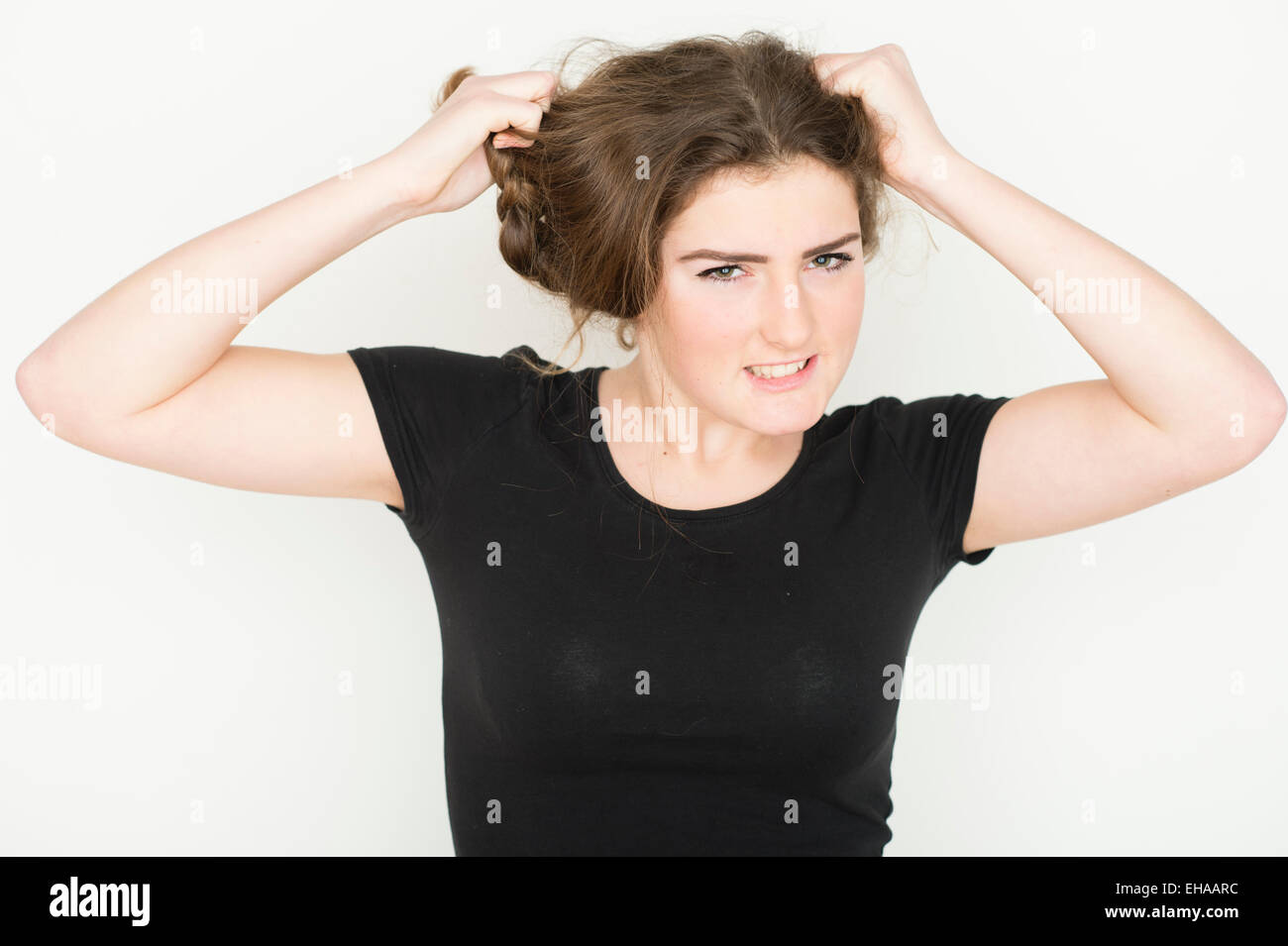 A Moody 13 14 Year Old Teenage Girl Tearing At Her Hair Uk Stock Photo A Moody 13 14 Year Old Teenage Girl Tearing At Her Hair Uk Stock Photo