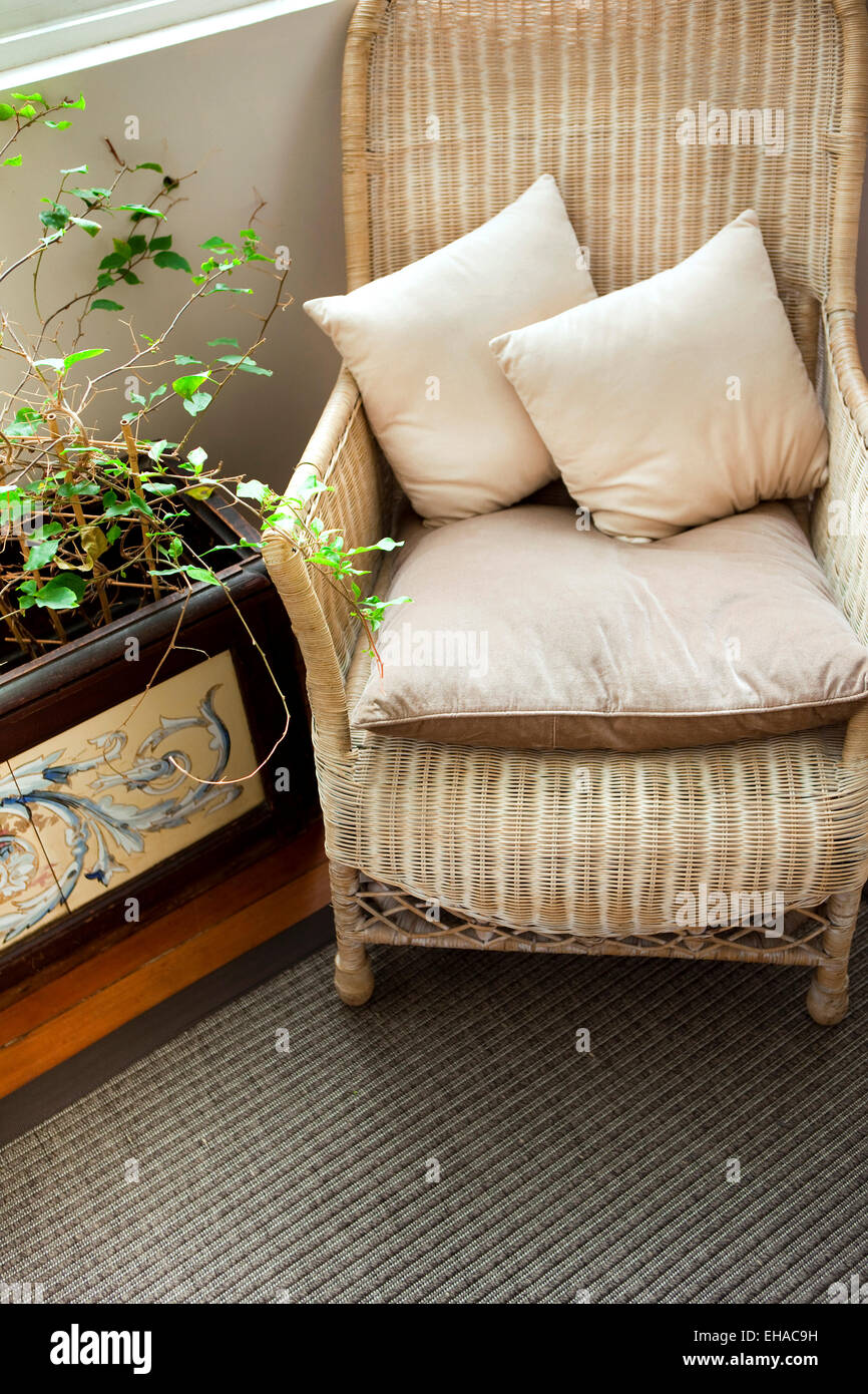 Wicker chair and cushions in a veranda Stock Photo