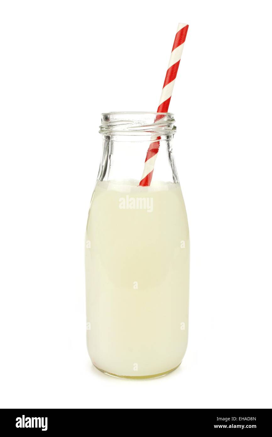 Milk with striped straw in a traditional bottle isolated on white Stock Photo