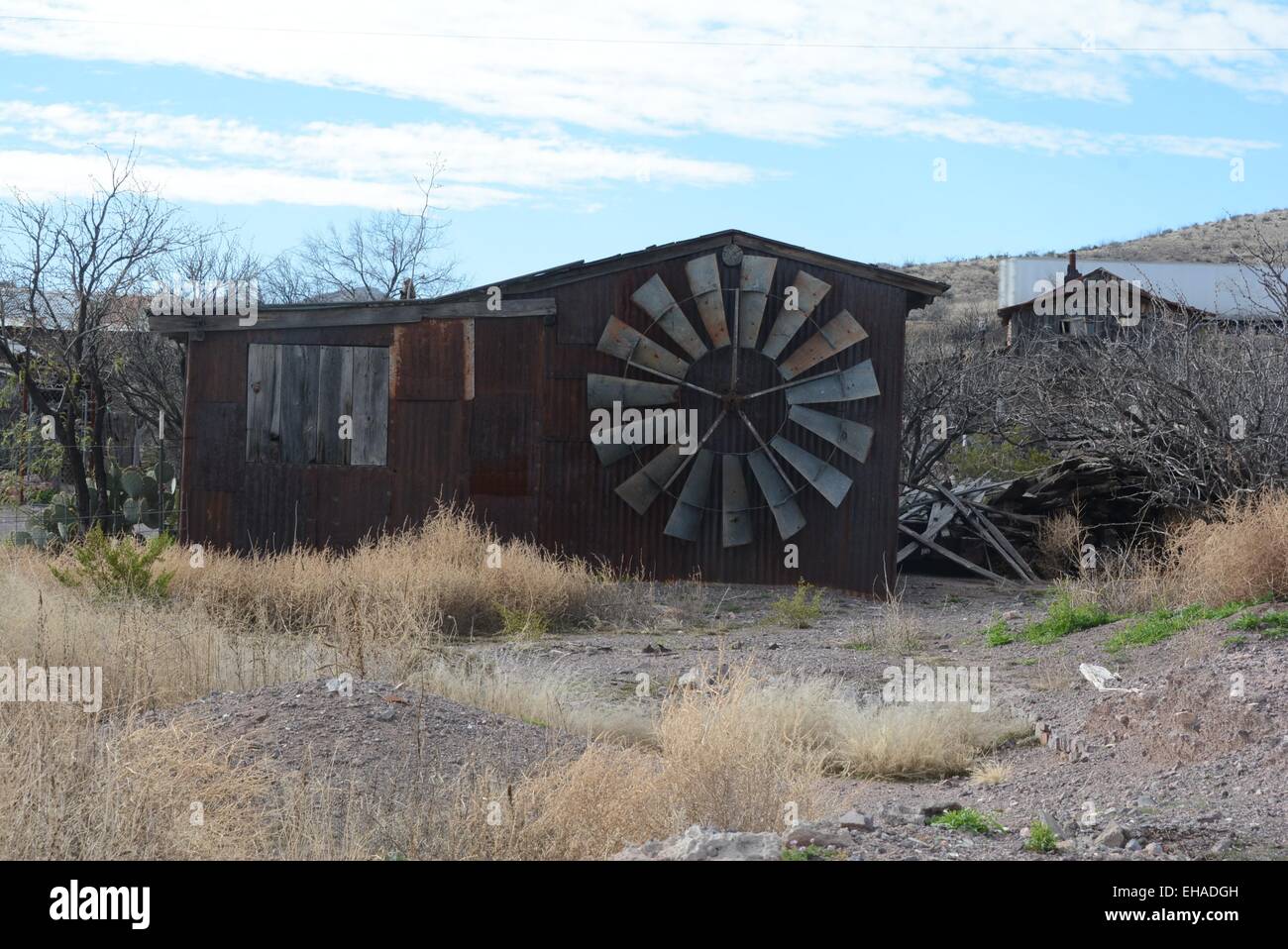 Windmill blades adorn old building at Steins Ghost Town, New Mexico - USA Stock Photo